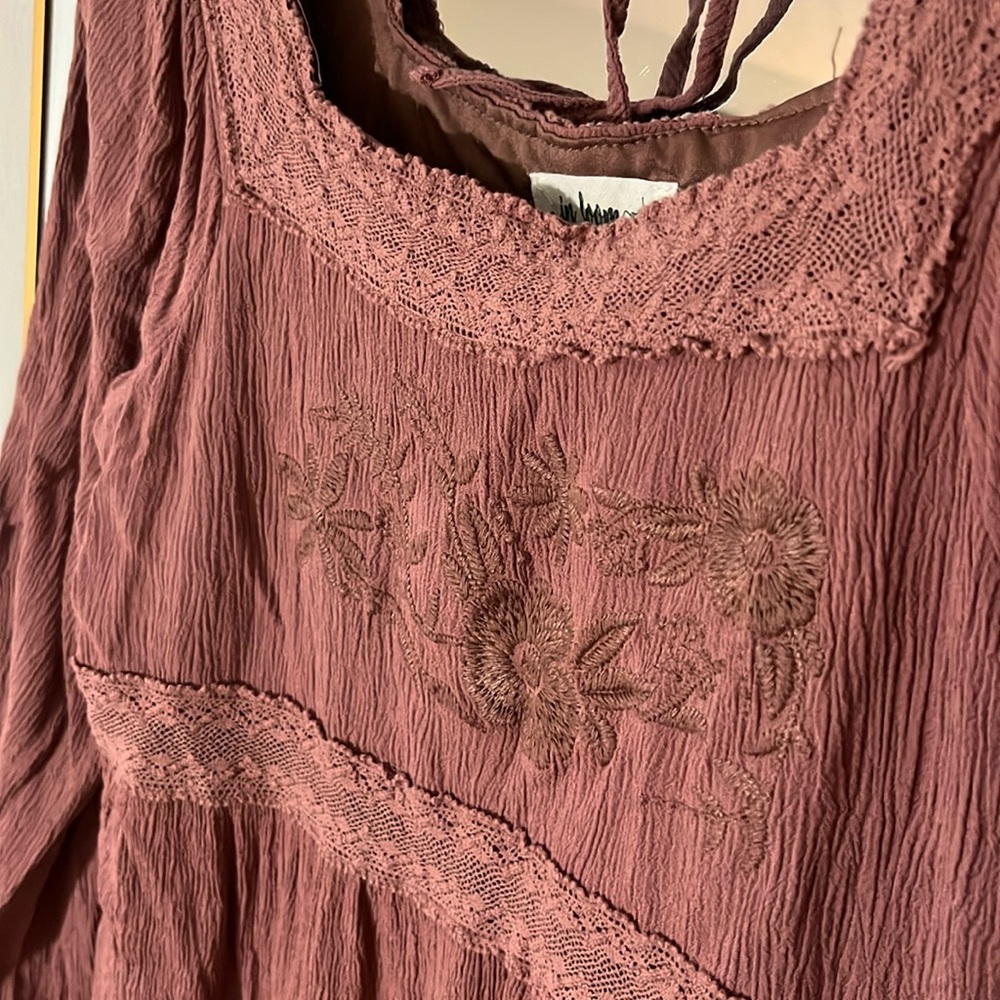 Rosy long sleeve dress with embroidered flower details on front and tie in back.
